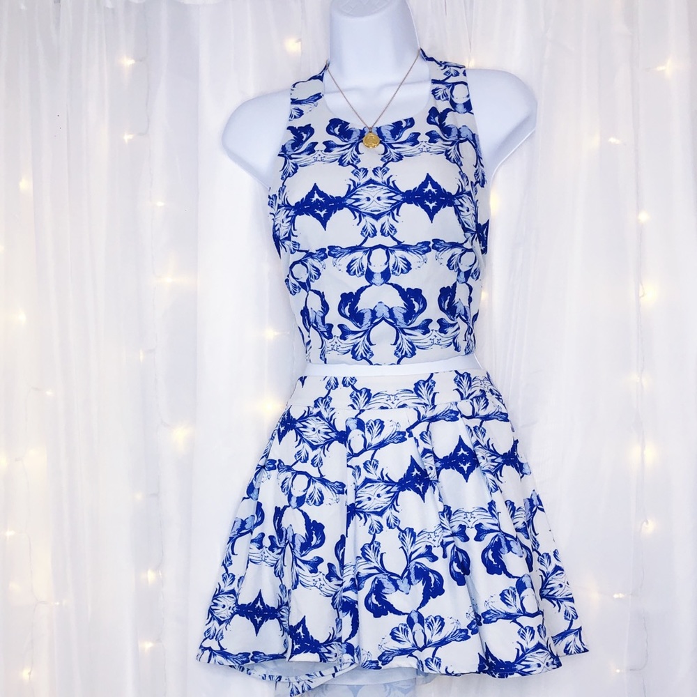 Two 2 piece white navy blue set